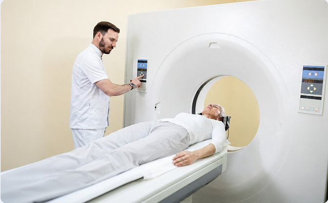 Technologist positioning a patient on the PET scanner bed